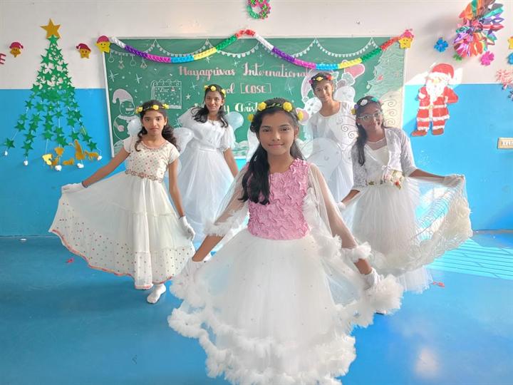 Students dressed as angels for the Christmas celebration