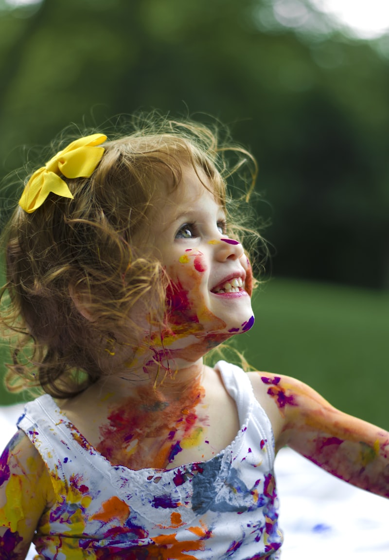 A child delighting in a creative activity