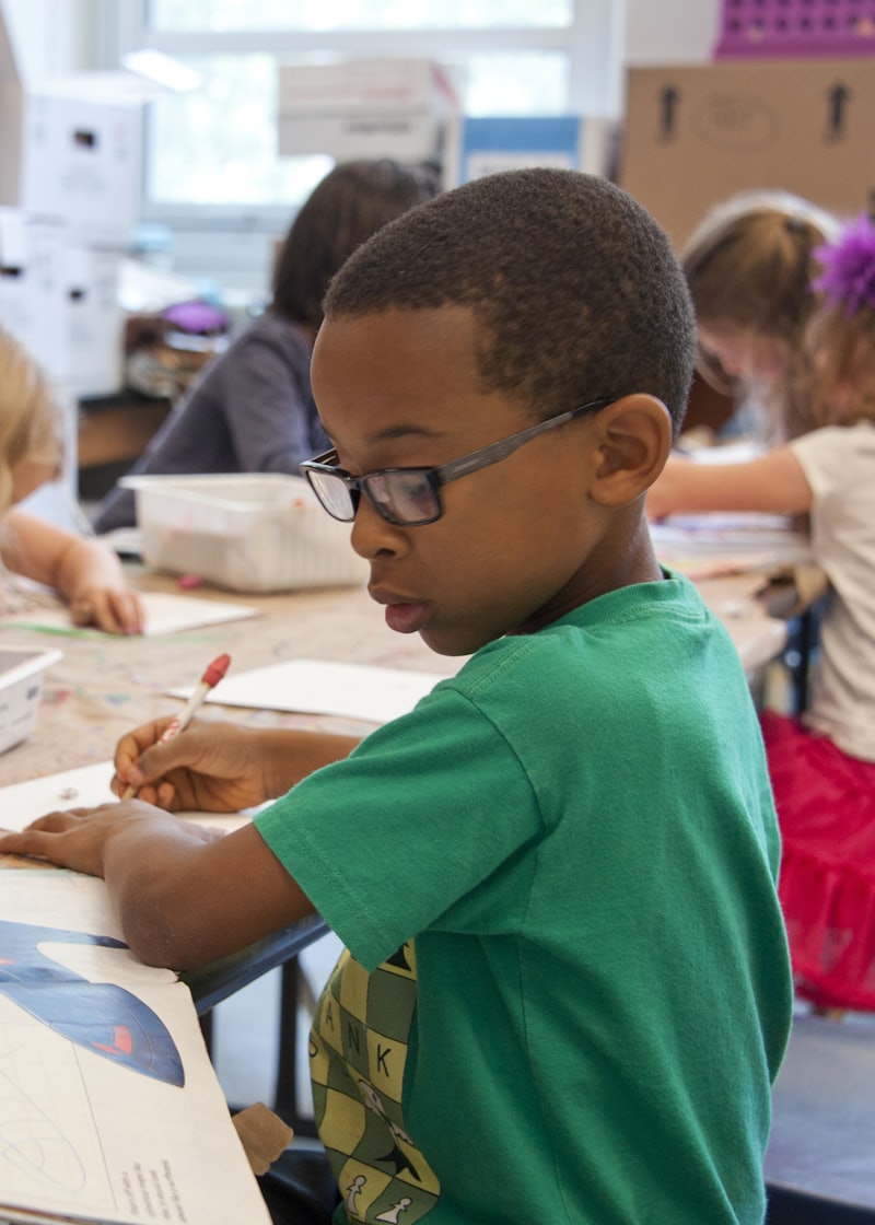A young student absorbed in their work