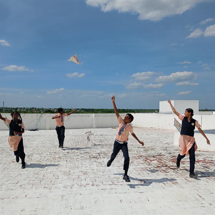 Students flying kites on the school terrace