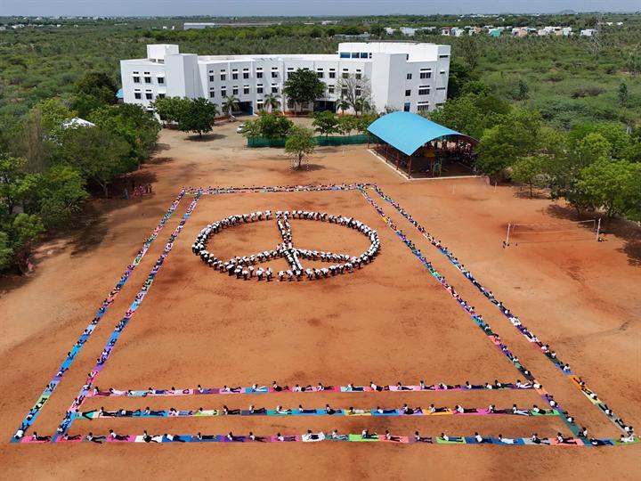 Students form a peace symbol on the school ground, seen from above