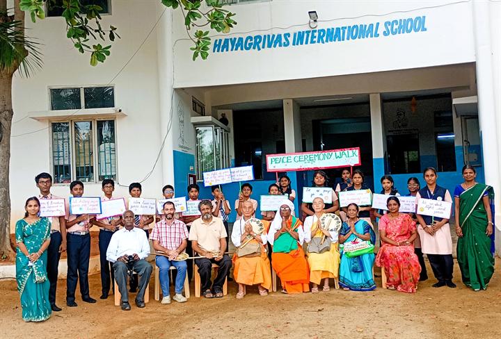 Students, teachers and guests at the peace walk outside the school