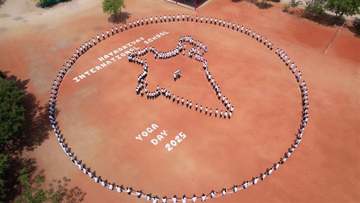 Students form a map of India on the school ground for International Yoga Day 2025